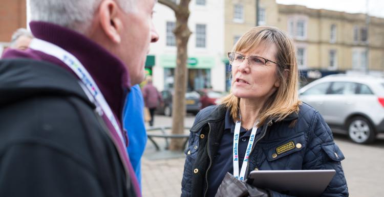 Healthwatch staff member talking to a member of the public about their experience