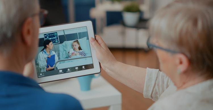 Elder people attending online teleconference on gadget. 