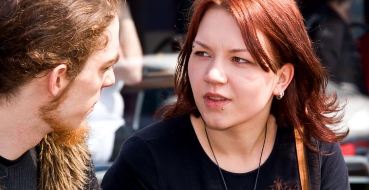 Young woman mid conversation with a young man