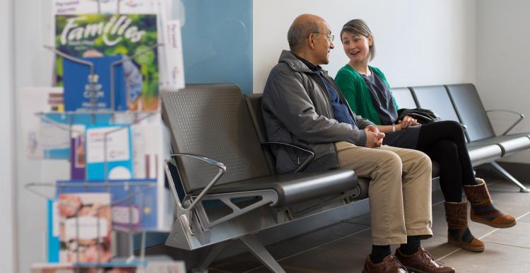 Two people talking in a waiting room