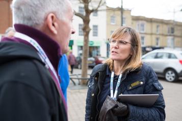 Healthwatch staff member talking to a member of the public about their experience