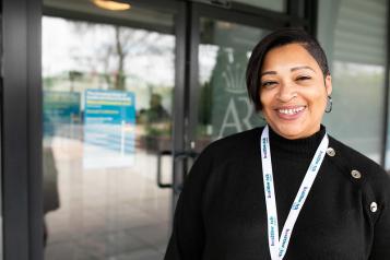 Woman smiling with a healthwatch lanyard on