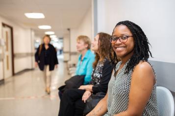 Woman smiling waiting in a hospital 